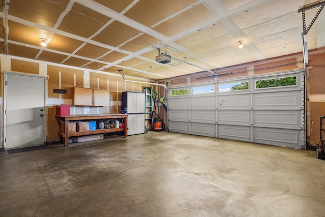 3608 Capricorn Way, Redding, CA 96002 - garage with a garage door opener and freestanding refrigerator