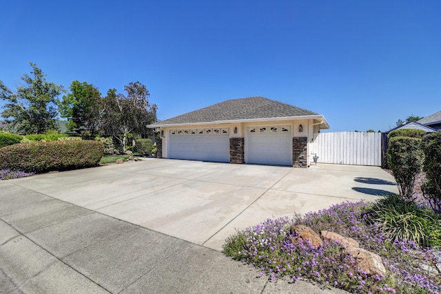 2654 Queens Way, Redding, CA 96001 - view of front of property featuring stone siding, concrete driveway, and a garage