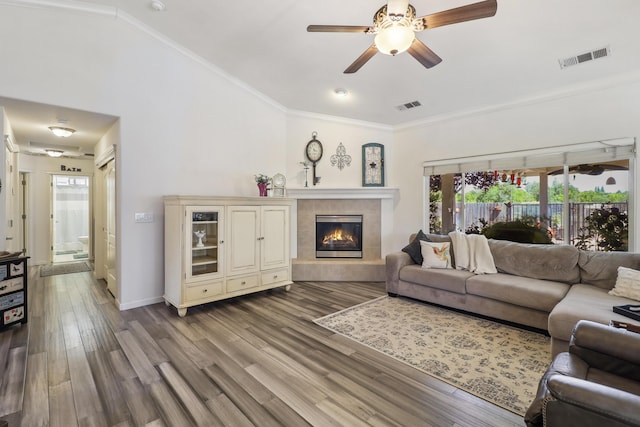 2654 Queens Way, Redding, CA 96001 - living room featuring crown molding, wood finished floors, a fireplace, a ceiling fan, and baseboards