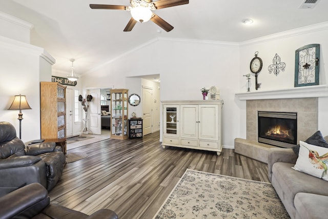 2654 Queens Way, Redding, CA 96001 - living room with lofted ceiling, ceiling fan, dark wood-style flooring, ornamental molding, and a tile fireplace