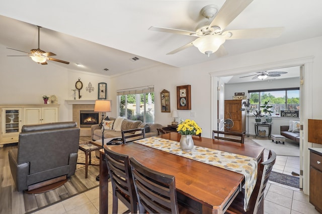 2654 Queens Way, Redding, CA 96001 - dining room featuring a ceiling fan, light tile patterned floors, and a glass covered fireplace