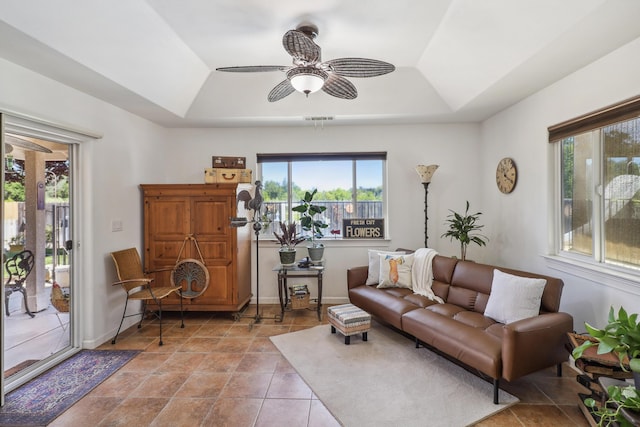 2654 Queens Way, Redding, CA 96001 - tiled living room with a tray ceiling, a ceiling fan, lofted ceiling, and baseboards