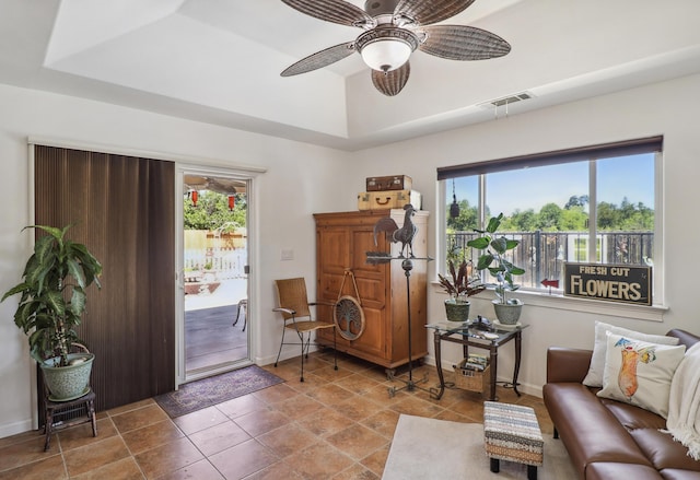 2654 Queens Way, Redding, CA 96001 - living area with plenty of natural light, a tray ceiling, ceiling fan, and baseboards
