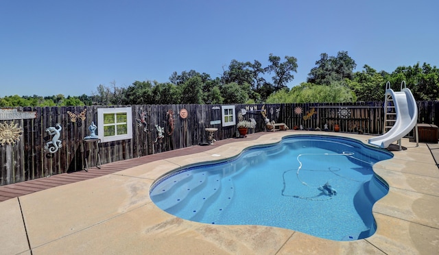 2654 Queens Way, Redding, CA 96001 - view of pool featuring a water slide, a fenced backyard, and a patio