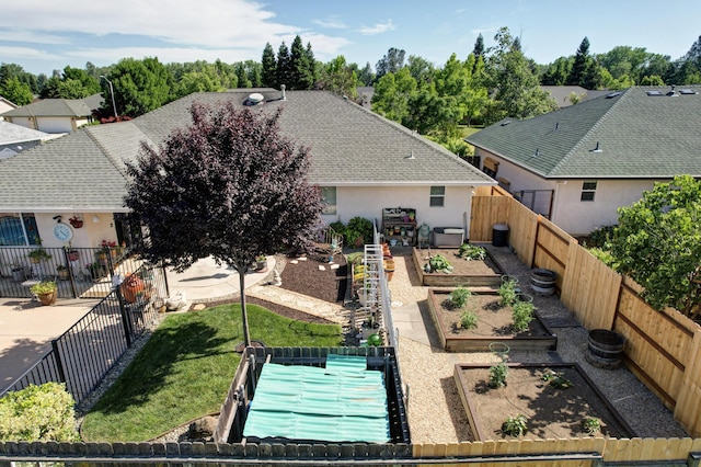 2654 Queens Way, Redding, CA 96001 - view of front of house with a vegetable garden, stucco siding, and roof with shingles