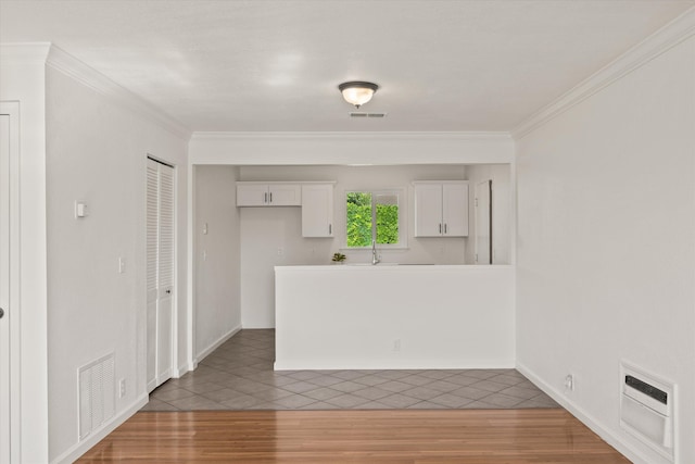 635 Nicklaus Ave, Red Bluff, CA 96080 - kitchen with light tile patterned floors, white cabinets, crown molding, a peninsula, and a sink