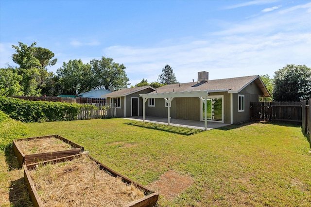 635 Nicklaus Ave, Red Bluff, CA 96080 - back of house featuring a vegetable garden and a patio area
