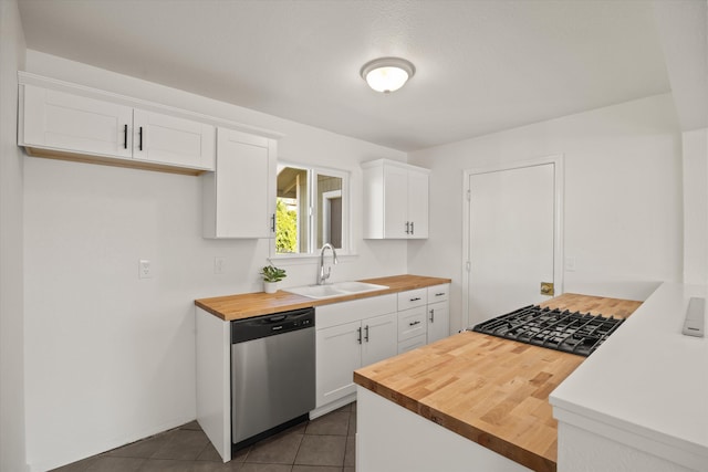 635 Nicklaus Ave, Red Bluff, CA 96080 - kitchen featuring butcher block countertops, stainless steel dishwasher, a sink, white cabinetry, and dark tile patterned flooring
