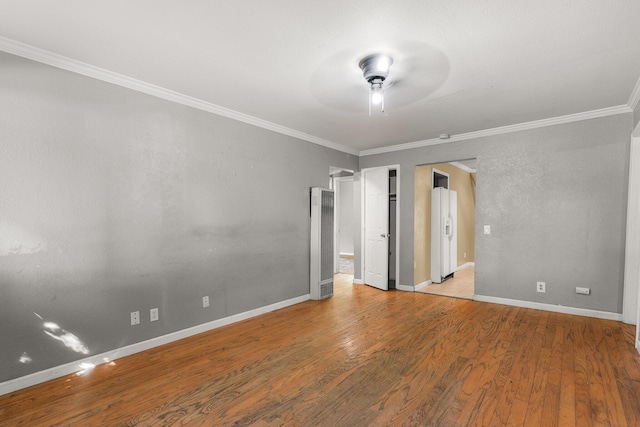 3262 Camellia St, Anderson, CA 96007 - unfurnished bedroom featuring a heating unit, ornamental molding, wood finished floors, white refrigerator with ice dispenser, and baseboards
