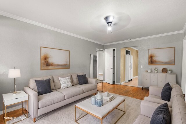 3262 Camellia St, Anderson, CA 96007 - living area with light wood finished floors, ornamental molding, a ceiling fan, baseboards, and a heating unit