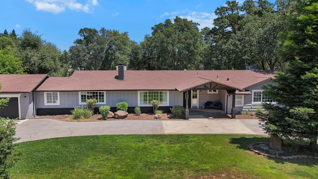 4223 Alta Mesa Dr, Redding, CA 96002 - ranch-style home with a front lawn, a chimney, driveway, and a garage