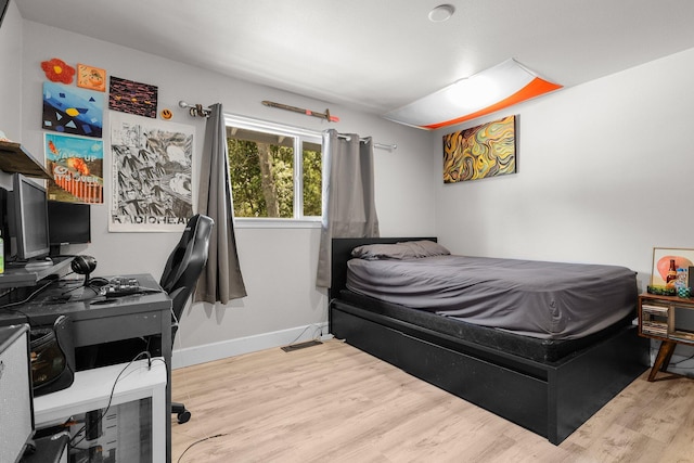 4223 Alta Mesa Dr, Redding, CA 96002 - bedroom featuring wood finished floors, an office area, and baseboards