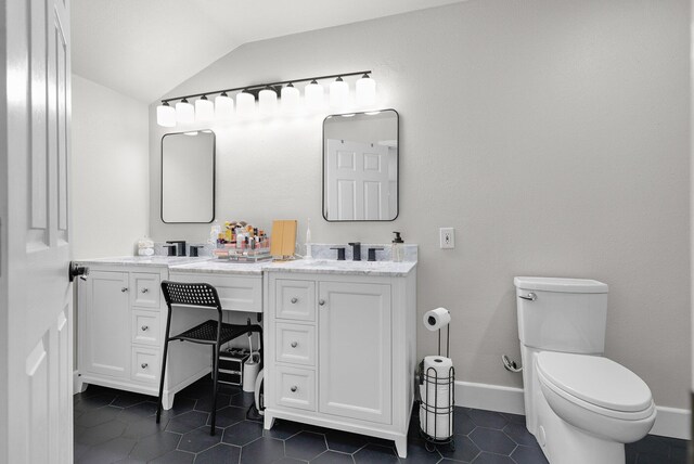 4223 Alta Mesa Dr, Redding, CA 96002 - bathroom featuring vaulted ceiling, double vanity, tile patterned floors, toilet, and baseboards