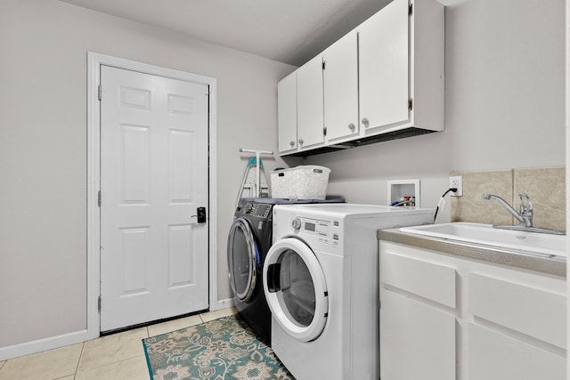 4223 Alta Mesa Dr, Redding, CA 96002 - washroom featuring cabinet space, washing machine and clothes dryer, light tile patterned flooring, and baseboards
