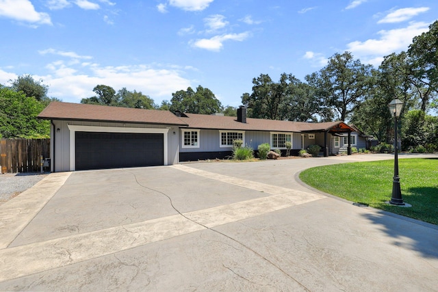 4223 Alta Mesa Dr, Redding, CA 96002 - ranch-style house featuring curved driveway, a garage, board and batten siding, and a chimney