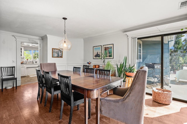 3330 Scenic Dr, Redding, CA 96001 - dining space featuring ornamental molding, dark wood-style floors, and a decorative wall