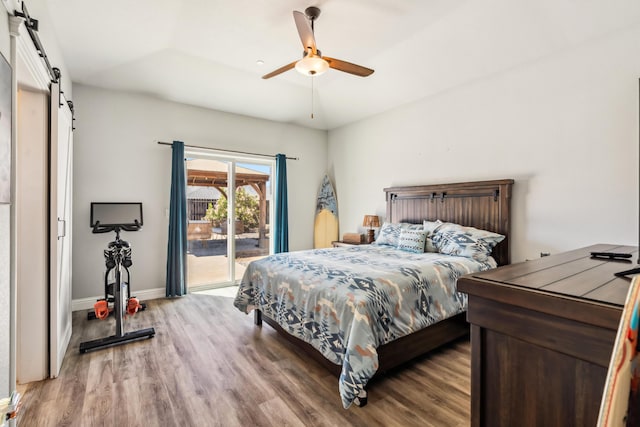 3126 Chaucer Way, Shasta Lake, CA 96019 - bedroom featuring a barn door, wood finished floors, access to outside, baseboards, and ceiling fan