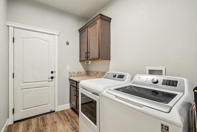 3126 Chaucer Way, Shasta Lake, CA 96019 - washroom with cabinet space, washer and dryer, light wood-style floors, and baseboards
