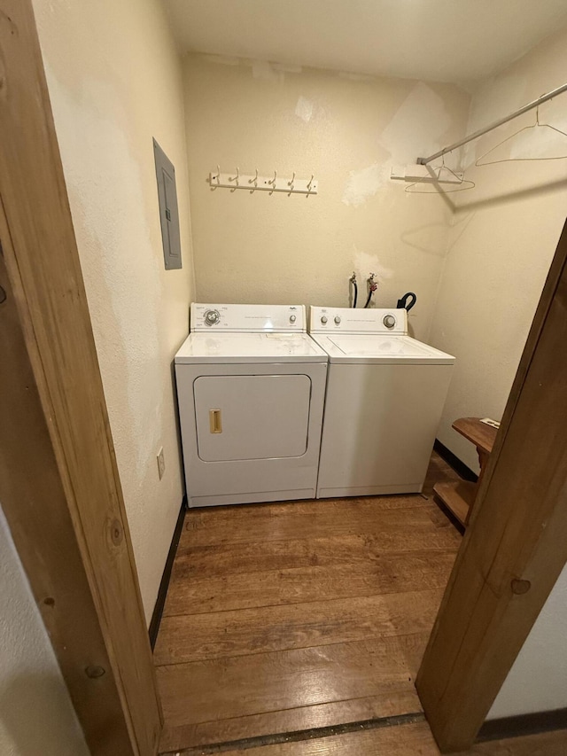 5890 Missouri Ln, Anderson, CA 96007 - washroom featuring washing machine and clothes dryer, hardwood / wood-style floors, electric panel, and a textured wall