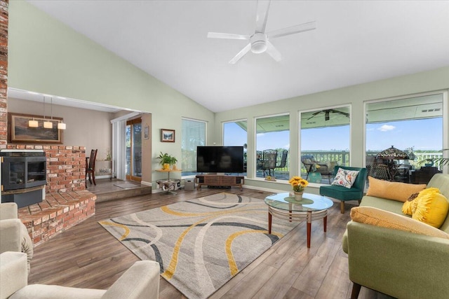 21350 Wilcox Rd, Red Bluff, CA 96080 - living room featuring wood finished floors, plenty of natural light, high vaulted ceiling, a ceiling fan, and a brick fireplace
