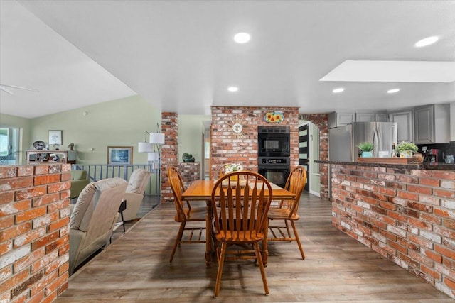 21350 Wilcox Rd, Red Bluff, CA 96080 - dining space with wood finished floors, brick wall, and recessed lighting