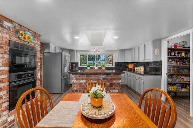 21350 Wilcox Rd, Red Bluff, CA 96080 - dining area featuring wood finished floors, recessed lighting, and a brick fireplace