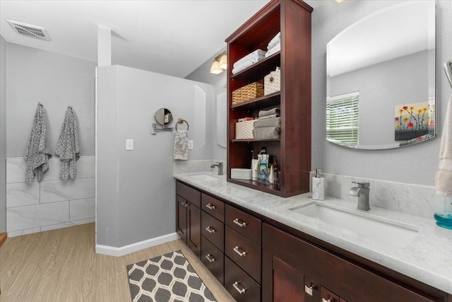 21350 Wilcox Rd, Red Bluff, CA 96080 - bathroom featuring wood finished floors, double vanity, and baseboards