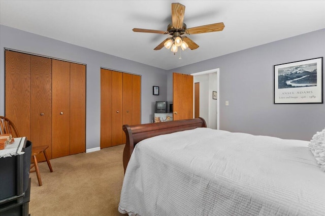 21350 Wilcox Rd, Red Bluff, CA 96080 - bedroom featuring multiple closets, light colored carpet, ceiling fan, and baseboards