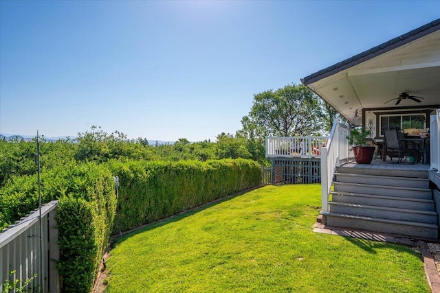 21350 Wilcox Rd, Red Bluff, CA 96080 - view of green lawn with a ceiling fan, a wooden deck, and stairway