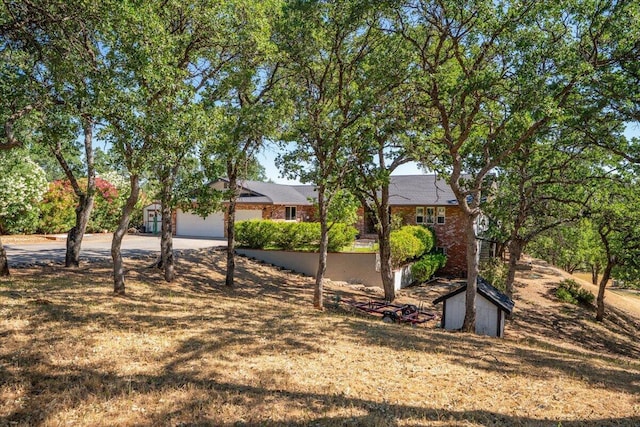 21350 Wilcox Rd, Red Bluff, CA 96080 - view of yard featuring concrete driveway and an attached garage