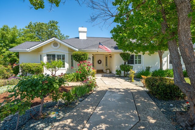 3811 Andes Dr, Redding, CA 96001 - single story home featuring a chimney, stucco siding, and a shingled roof