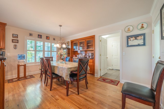 3811 Andes Dr, Redding, CA 96001 - dining room with a chandelier, light wood finished floors, baseboards, and ornamental molding