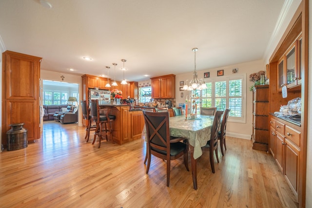 3811 Andes Dr, Redding, CA 96001 - dining room featuring light wood-style floors, healthy amount of natural light, a chandelier, recessed lighting, and crown molding