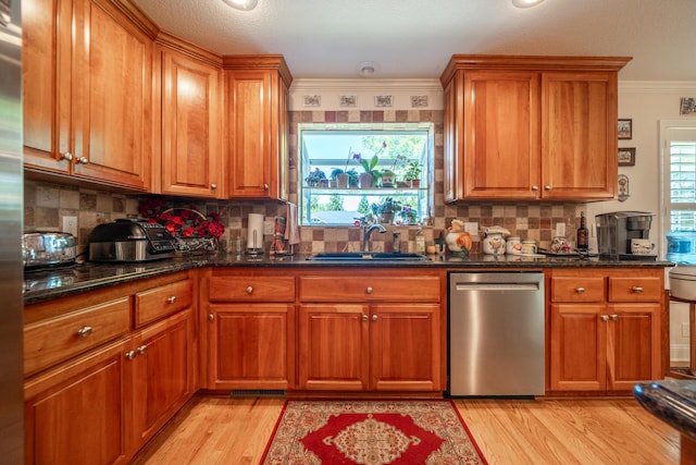 3811 Andes Dr, Redding, CA 96001 - kitchen with appliances with stainless steel finishes, a sink, brown cabinets, light wood-style flooring, and crown molding