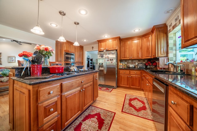 3811 Andes Dr, Redding, CA 96001 - kitchen featuring appliances with stainless steel finishes, a sink, brown cabinets, light wood-style flooring, and recessed lighting