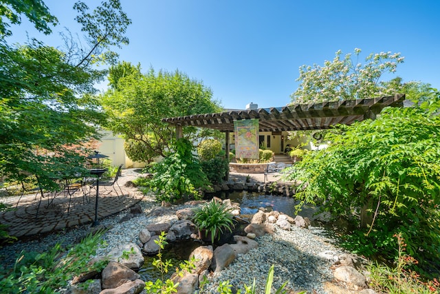 3811 Andes Dr, Redding, CA 96001 - view of yard featuring a pergola, a patio area, and a small pond