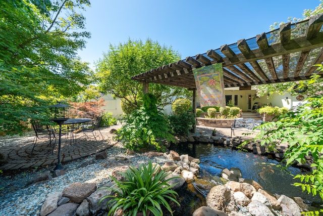 3811 Andes Dr, Redding, CA 96001 - view of yard with a small pond, a patio area, and a pergola