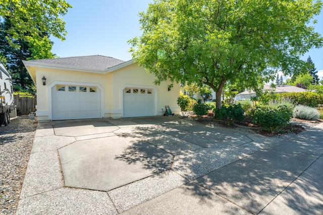 3811 Andes Dr, Redding, CA 96001 - view of front of home with a garage, stucco siding, and driveway