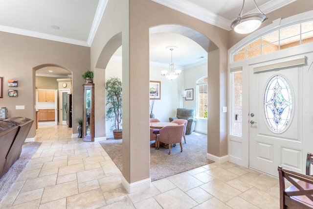 2830 Montana Sky Dr, Redding, CA 96002 - entryway featuring arched walkways, stone tile floors, ornamental molding, plenty of natural light, and baseboards