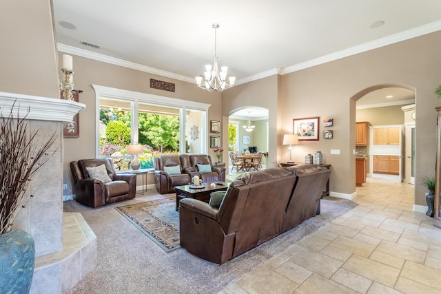 2830 Montana Sky Dr, Redding, CA 96002 - living room with arched walkways, a chandelier, crown molding, baseboards, and stone tile floors