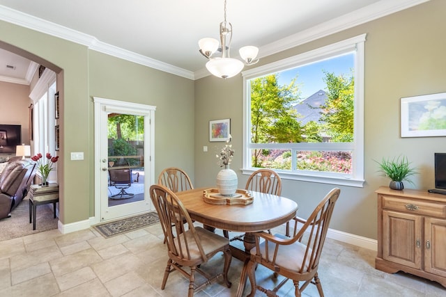 2830 Montana Sky Dr, Redding, CA 96002 - dining room with arched walkways, crown molding, baseboards, light stone finish floors, and a chandelier