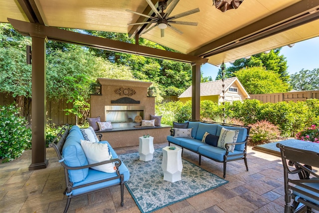 2830 Montana Sky Dr, Redding, CA 96002 - fenced backyard featuring an outdoor living space with a fireplace, a patio, ceiling fan, and an outdoor structure