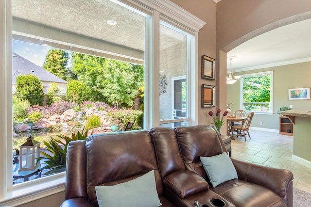 2830 Montana Sky Dr, Redding, CA 96002 - living room featuring ornamental molding, arched walkways, and baseboards