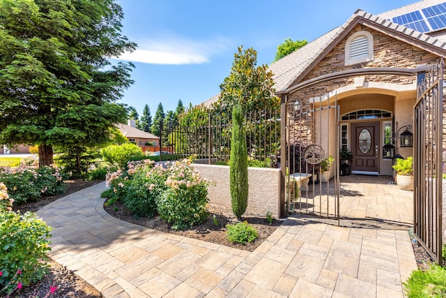2830 Montana Sky Dr, Redding, CA 96002 - property entrance featuring stone siding and a gate
