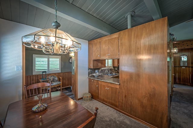 19370 Mountain Maple Rd, Lakehead, CA 96051 - carpeted dining space with wainscoting, a chandelier, wood ceiling, wood walls, and a sink