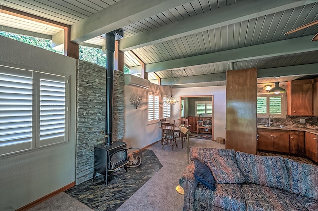 19370 Mountain Maple Rd, Lakehead, CA 96051 - carpeted living area with a wood stove, a sink, baseboards, and a wall mounted air conditioner
