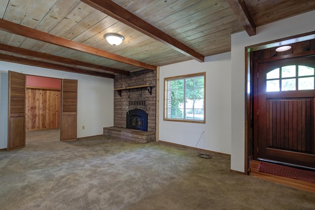 2915 Rockabye Ln, Redding, CA 96002 - unfurnished living room featuring healthy amount of natural light, wooden ceiling with exposed beams, carpet floors, and a fireplace