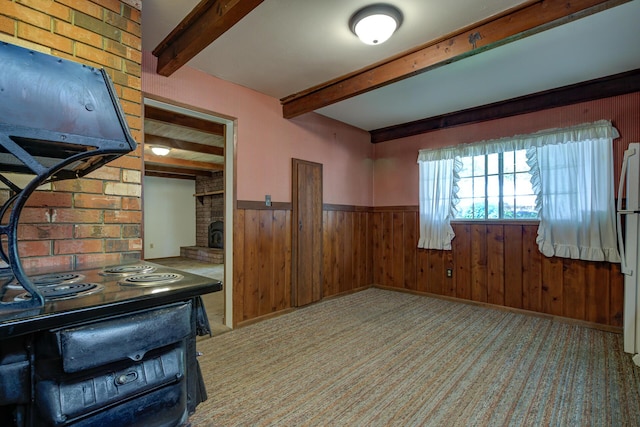 2915 Rockabye Ln, Redding, CA 96002 - unfurnished dining area featuring beamed ceiling, wooden walls, a wainscoted wall, a brick fireplace, and light colored carpet