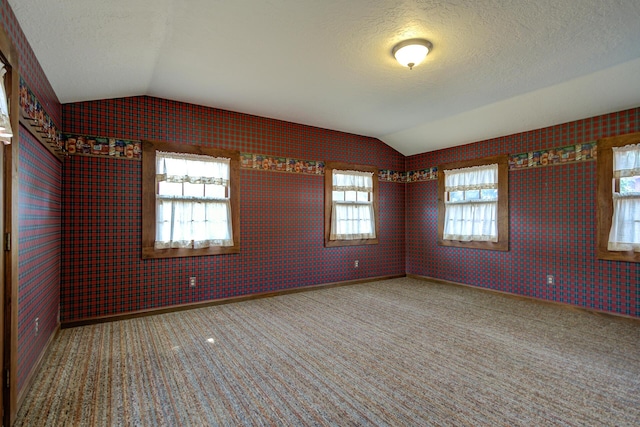 2915 Rockabye Ln, Redding, CA 96002 - empty room with vaulted ceiling, a textured ceiling, and carpet floors