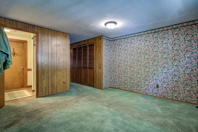 2915 Rockabye Ln, Redding, CA 96002 - unfurnished bedroom with wallpapered walls, carpet flooring, a closet, baseboards, and wood walls